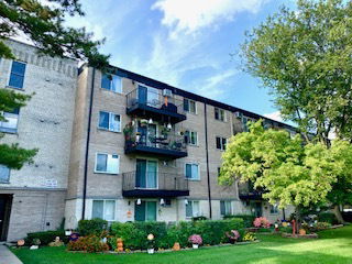 Front view of a multi-story residential building with balconies.