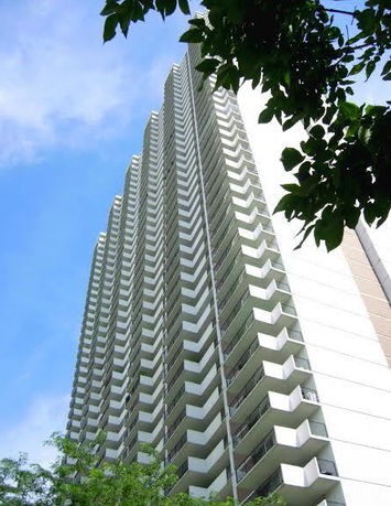 Front view of a high-rise building with multiple balconies.