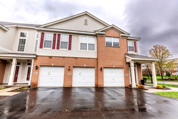 Front view of a two-story house with a triple garage.