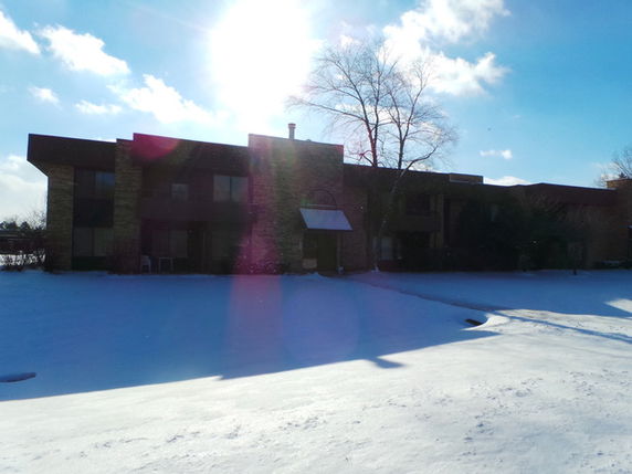 Front view of a snow-covered multi-story building.