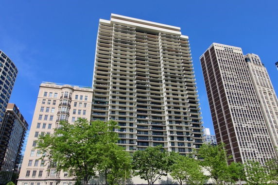 Front view of a high-rise apartment building with multiple balconies.
