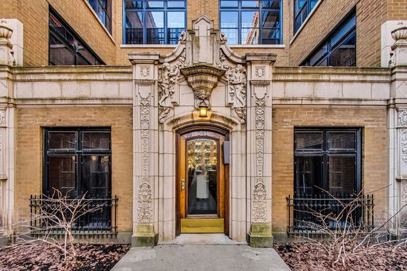 Front view of a building with detailed stonework and decorative elements.
