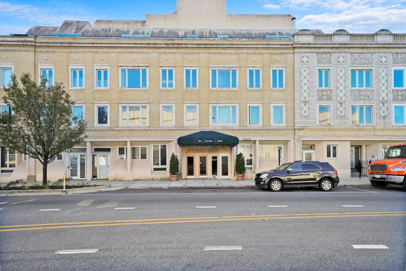 Front view of a multi-story building with decorative detailing.