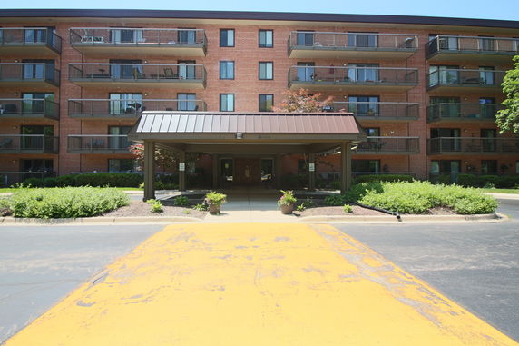 Front view of a multi-story residential building with balconies.