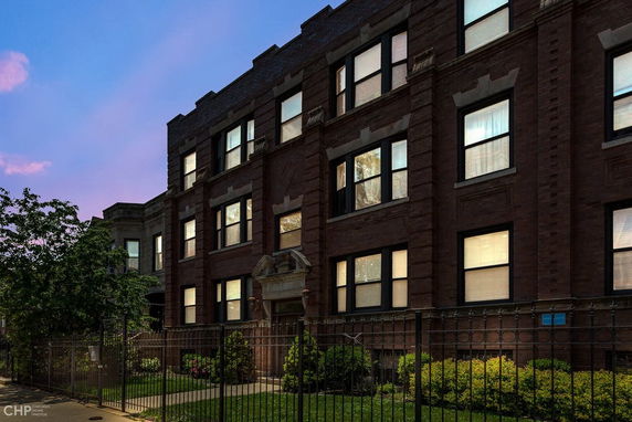 Front view of a three-story brick apartment building.