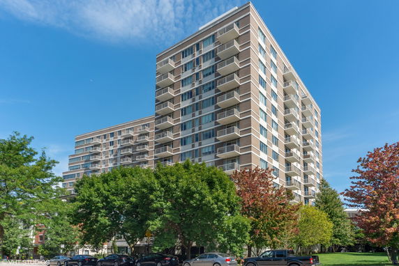 Front view of a multi-story residential building with balconies.