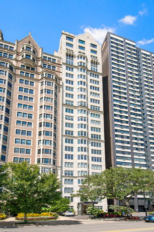 Front view of a tall multi-story building with architectural details.