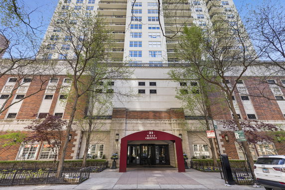 Front view of a multi-story building with a brick and concrete facade.