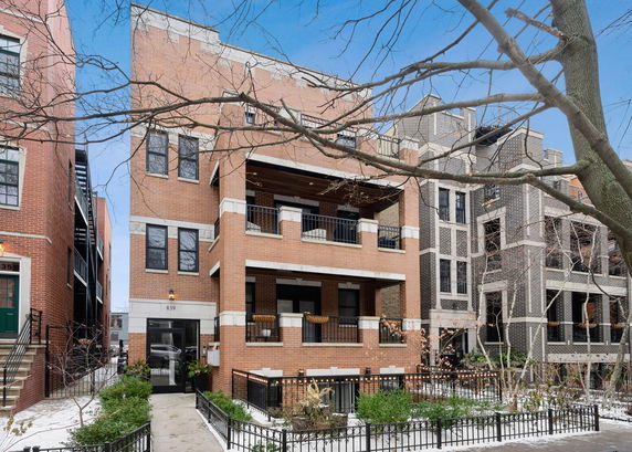 Front view of a multi-story brick residential building.
