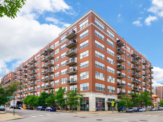 Front view of a multi-story residential building with balconies.