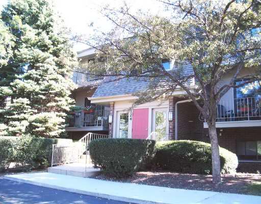 Front view of a two-story building with a prominent entrance and balconies.