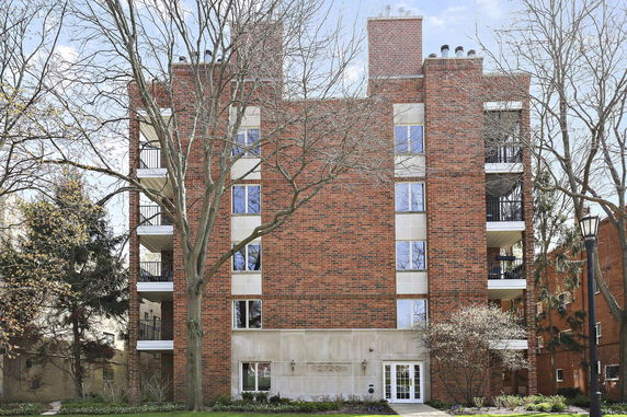 Front view of a multi-story brick apartment building.