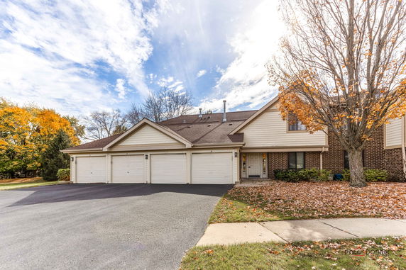 Front view of a house with a triple garage and brick exterior.
