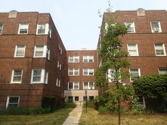 Front view of a three-story brick apartment building.