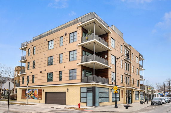 Front view of a multi-story building with balconies.