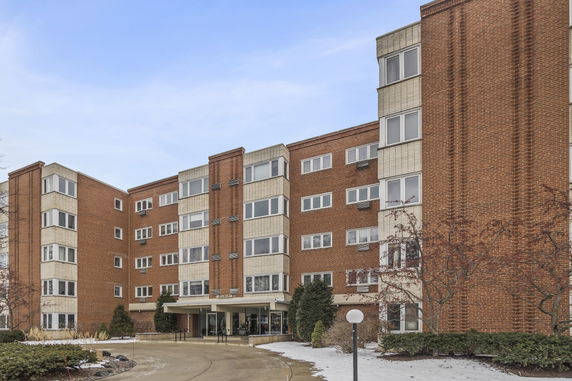 Front view of a multi-story brick apartment building.