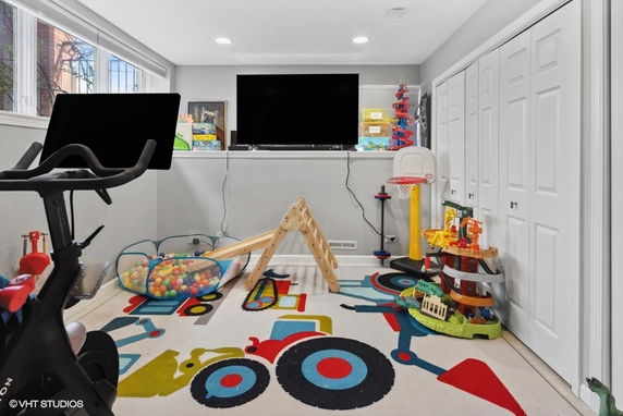 Indoor play area with children's toys and exercise equipment.