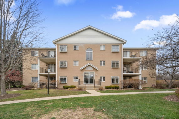 Front view of a three-story brick apartment building.