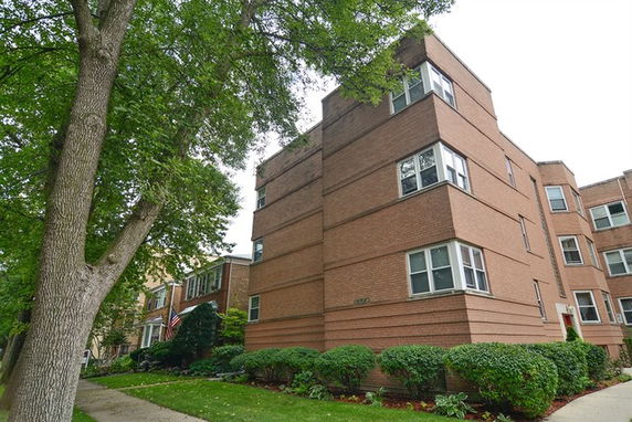 Front view of a multi-story brick apartment building