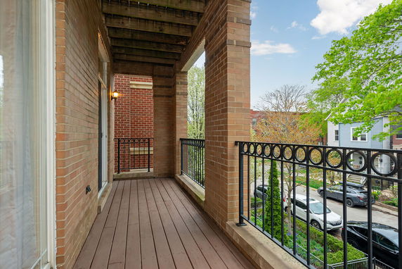 Balcony view showing adjacent street and nearby houses.
