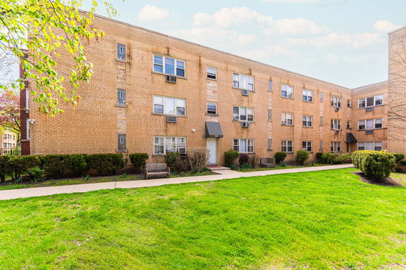 Front view of a three-story brick apartment building.