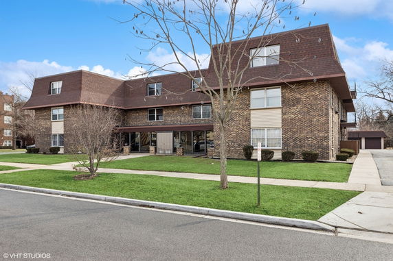 Front view of a multi-story brick apartment building.