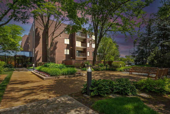 Front view of a multi-story brick building with balconies.