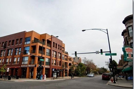Front view of a multi-story commercial building at a street intersection.