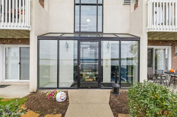 Front view of a multi-story building with glass entryway.