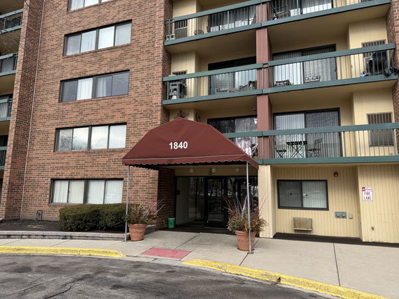 Front view of a multi-story residential building with balconies.