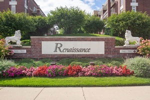 Front view of a brick building with 'Renaissance' sign and decorative lions.