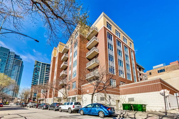 Front view of a multi-story residential building with balconies.