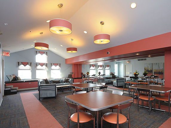 Interior view of a club house with seating and tables.