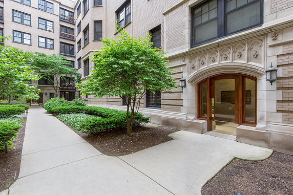 Entrance to a multi-story brick building with ornate arch detailing.