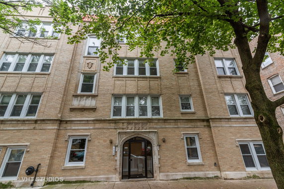 Front view of a multi-story brick apartment building.