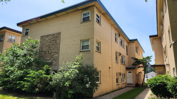 Front view of a multi-story brick apartment building.