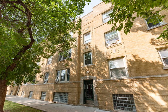 Front view of a multi-story brick apartment building.
