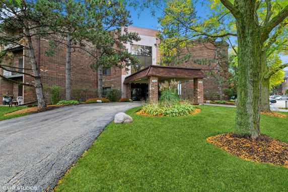 Front view of a building with an entrance canopy and brick facade.