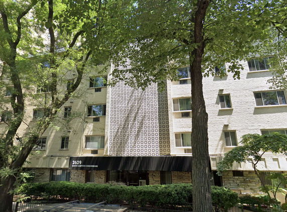 Front view of a mid-rise condominium building with a decorative facade and multiple windows.