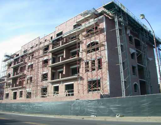 Front view of a building under construction with scaffolding.