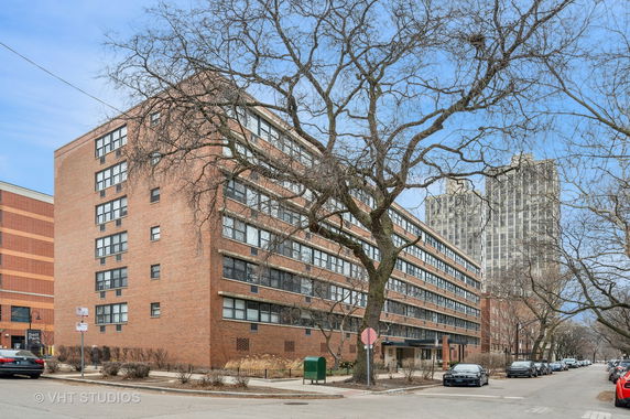 Front view of a multi-story brick apartment building.