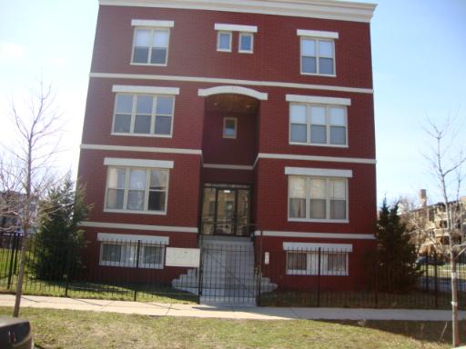 Front view of a three-story brick apartment building.