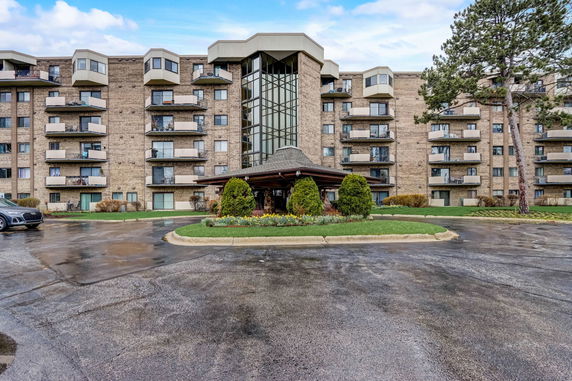 Front view of a multi-story residential building with balconies.