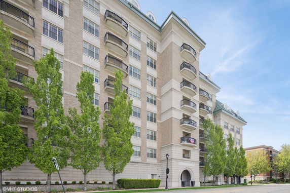 Front view of a multi-story residential building with balconies.