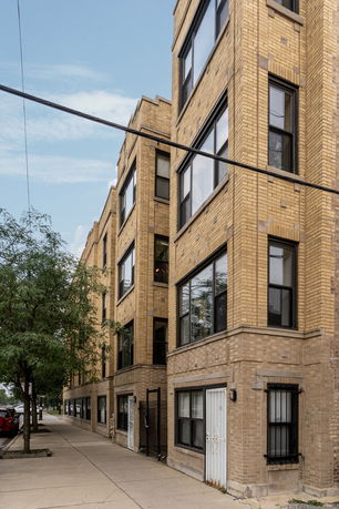 View of a multi-story brick apartment building.