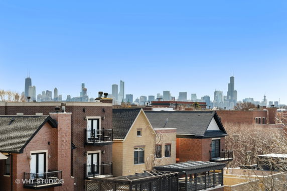 Panoramic view of residential buildings with a city skyline in the background.