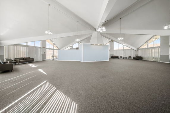 Spacious indoor club house area with high ceilings and modern lighting.