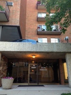 Front view of a multi-story brick building with balconies.