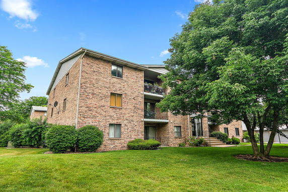 Front view of a three-story brick apartment building