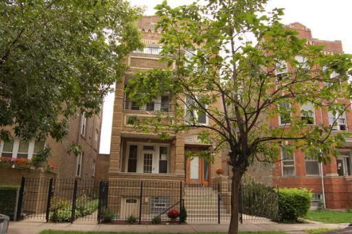 Front view of a multi-story brick apartment building.